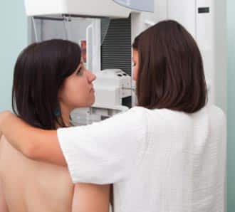 A doctor screening a patient for breast cancer. 
