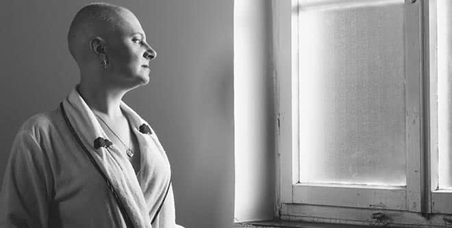 A cancer patient looks out the window.