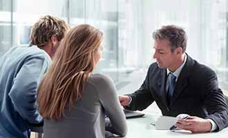 Two clients talking to a lawyer with regards to a personal injury case