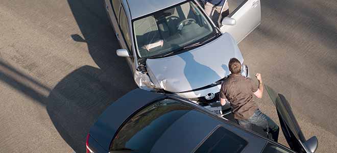 two men getting ready to fight after a car accident