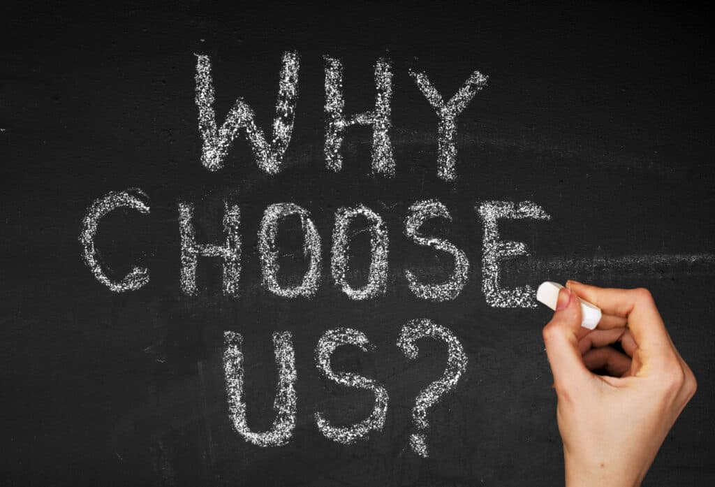 "Why Choose Us? written on a chalk board. 